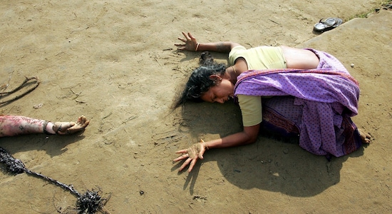 SENSITIVE MATERIAL. THIS IMAGE MAY OFFEND OR DISTURB FILE PHOTO: An Indian woman mourns the death of her relative who was killed in a tsunami on Sunday in Cuddalore, south of the southern Indian city of Madras, December 28, 2004. REUTERS/Arko Datta