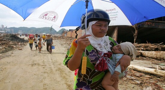 FILE PHOTO: An Indonesian woman carries her child in Lhoknga district, southwest of Banda Aceh, as they head towards the provincial capital to seek food and shelter following the deadly tsunami, on the Indonesian island of Sumatra January 1, 2005. REUTERS/Beawiharta FILE PHOTO: An Indonesian woman carries her child in Lhoknga district, southwest of Banda Aceh, as they head towards the provincial capital to seek food and shelter following the deadly tsunami, on the Indonesian island of Sumatra January 1, 2005. REUTERS/Beawiharta