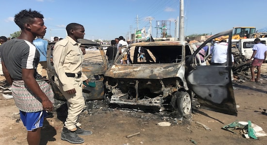 Somali security assess the scene of a car bomb explosion at a checkpoint in Mogadishu, Somalia December 28, 2019. REUTERS/Feisal Omar