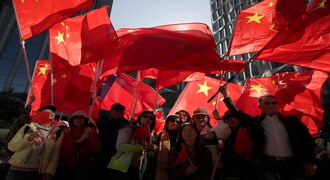 Pro-Beijing supporters wave the Chinese national flags during a rally in Hong Kong on Saturday, Dec. 7, 2019. Six months of unrest have tipped Hong Kong's already weak economy into recession. (AP Photo/Mark Schiefelbein)