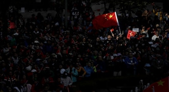 Pro-Beijing supporters wave the Chinese national flags during a rally in Hong Kong on Saturday, Dec. 7, 2019. Six months of unrest have tipped Hong Kong's already weak economy into recession. (AP Photo/Mark Schiefelbein)