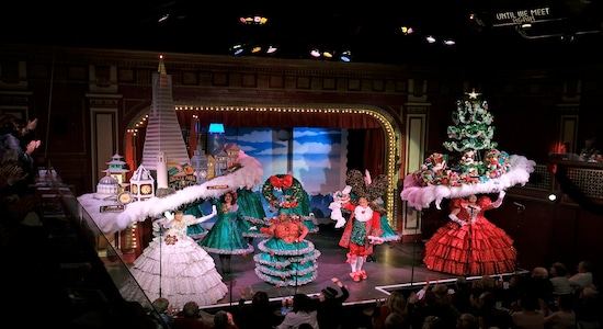 In this Wednesday, Dec. 4, 2019 photo, performers fill the stage for the final number of the musical &quot;Beach Blanket Babylon&quot; in San Francisco. The campy small San Francisco show that's been a must-see for tourists and locals alike for more than 45 years is closing its curtain. The show, which spoofs politics and pop culture, started in 1974, making it the nation's longest continuously running musical revue. Its final performance is set for New Year’s Eve. (AP Photo/Eric Risberg)