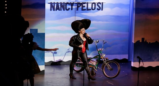 In this Wednesday, Dec. 4, 2019 photo, Speaker of the House Nancy Pelosi is portrayed by Jacqui Heck during a performance of the musical &quot;Beach Blanket Babylon&quot; in San Francisco. The campy small San Francisco show that's been a must-see for tourists and locals alike for more than 45 years, making it the nation's longest continuously running musical revue, is closing its curtain. Its final performance is set for New Year’s Eve. (AP Photo/Eric Risberg)