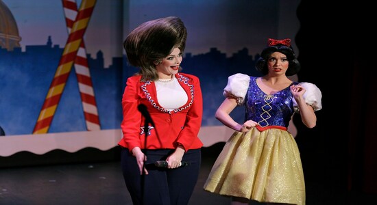 In this Wednesday, Dec. 4, 2019 photo, Hillary Clinton and Snow White are portrayed by Jennifer Morrison, left, and Ruby Day, right, during a performance of the musical Beach Blanket Babylon in San Francisco. The campy small San Francisco show that's been a must-see for tourists and locals alike for more than 45 years, making it the nation's longest continuously running musical revue, is closing its curtain. Its final performance is set for New Year’s Eve. (AP Photo/Eric Risberg)