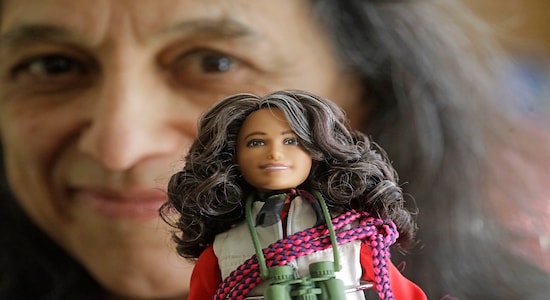 This Dec. 3, 2019, photo, ecologist Nalini Nadkarni is shown in her lab on the University of Utah campus in Salt Lake City holding a Barbie created to look like her when she's climbing into the treetops to study the rainforest canopy. Nadkarni's childhood climbing trees shaped her career and now she's hoping she can get help kids interested in science in an new way: Barbies. Nadkarni has long created her own &quot;treetop Barbies&quot; and has now helped Mattel and National Geographic create a line of dolls with careers in science and conservation. (AP Photo/Rick Bowmer)