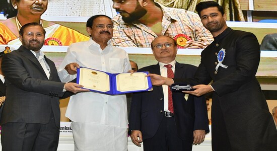 Vice President Venkaiah Naidu, second left, presents the national film award to Bollywood actor Vicky Kaushal , right, who shared the best actor award with actor Ayushmann Khurrana during the national film awards ceremony in New Delhi, India, Monday, Dec.23, 2019. Information and Broadcasting Minister Prakash Javdekar is on left. (AP Photo) Vice President Venkaiah Naidu, second left, presents the national film award to Bollywood actor Vicky Kaushal , right, who shared the best actor award with actor Ayushmann Khurrana during the national film awards ceremony in New Delhi, India, Monday, Dec.23, 2019. Information and Broadcasting Minister Prakash Javdekar is on left. (AP Photo)