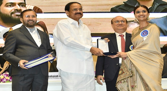 Vice President Venkaiah Naidu, second left, presents the best actress award to Keerthy Suresh, right, during the national film awards ceremony in New Delhi, India, Monday, Dec.23, 2019. Information and Broadcasting Minister Prakash Javdekar is on left. (AP Photo)
