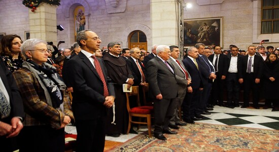 Palestinian President Mahmoud Abbas attends a Christmas midnight mass at the Church of the Nativity in the West Bank town of Bethlehem on Wednesday, Dec. 25, 2019. The Church of the Nativity, where Christians believe Jesus was born, hosted Palestinian dignitaries and pilgrims from around the world for the midnight Mass. (Mussa Qawasma/Pool Photo via AP)
