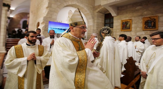 Archbishop Pierbattista Pizzaballa leads a Christmas midnight mass at the Church of the Nativity in the West Bank town of Bethlehem on Wednesday, Dec. 25, 2019. The Church of the Nativity, where Christians believe Jesus was born, hosted Palestinian dignitaries and pilgrims from around the world for the midnight Mass. (Mussa Qawasma/Pool Photo via AP)