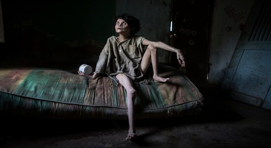 In this Nov. 28, 2019 photo published on Dec. 27, Zaida Bravo, who suffers Parkinson's disease and is malnourished, waits for dinner on her dirty mattress in her one room living quarters in Maracaibo, Venezuela. The 48-year-old's sister Ana Bravo brings her food when she can, but for the last four years the older sister has had trouble affording even rice or cornmeal. "We can't find her medicine or even know how to help her, so we're letting what happens happen," Ana Bravo, 57, said. "Sometimes, I'm afraid to go inside and find her dead." (AP Photo/Rodrigo Abd) In this Nov. 28, 2019 photo published on Dec. 27, Zaida Bravo, who suffers Parkinson's disease and is malnourished, waits for dinner on her dirty mattress in her one room living quarters in Maracaibo, Venezuela. The 48-year-old's sister Ana Bravo brings her food when she can, but for the last four years the older sister has had trouble affording even rice or cornmeal. "We can't find her medicine or even know how to help her, so we're letting what happens happen," Ana Bravo, 57, said. "Sometimes, I'm afraid to go inside and find her dead." (AP Photo/Rodrigo Abd)