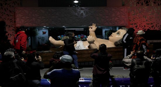 People gather around a giant baby Jesus statue in preparation for Christmas Eve in Mexico City, Monday, Dec. 23, 2019. (AP Photo/Marco Ugarte) People gather around a giant baby Jesus statue in preparation for Christmas Eve in Mexico City, Monday, Dec. 23, 2019. (AP Photo/Marco Ugarte)