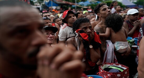 Fans of Brazil's Flamengo soccer team watch a live broadcast of the FIFA Club World Cup final soccer match against England's Liverpool, at the Rocinha slum in Rio de Janeiro, Brazil, Saturday, Dec. 21, 2019. (AP Photo/Leo Correa) Fans of Brazil's Flamengo soccer team watch a live broadcast of the FIFA Club World Cup final soccer match against England's Liverpool, at the Rocinha slum in Rio de Janeiro, Brazil, Saturday, Dec. 21, 2019. (AP Photo/Leo Correa)