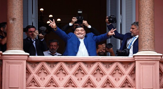 Former soccer great Diego Maradona flashes victory signs to fans below at the Casa Rosada government house after meeting with Argentine President Alberto Fernandez in Buenos Aires, Argentina, Thursday, Dec. 26, 2019. (AP Photo/Marcos Brindicci) Former soccer great Diego Maradona flashes victory signs to fans below at the Casa Rosada government house after meeting with Argentine President Alberto Fernandez in Buenos Aires, Argentina, Thursday, Dec. 26, 2019. (AP Photo/Marcos Brindicci)