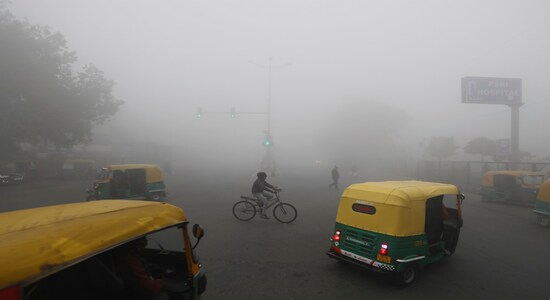 A cyclist pedals across a crossing amidst early morning dense fog in New Delhi, India, Monday, Dec. 30, 2019. Delhi, which is witnessing the longest spell of cold weather in the last 22 years, woke up to a blanket of dense fog engulfing most parts of the national capital on Monday morning, disrupting rail, road and air traffic adversely. (AP Photo/Manish Swarup)