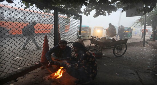 People warm themselves up in front of a bon fire amidst early morning dense fog in New Delhi, India, Monday, Dec. 30, 2019. Delhi, which is witnessing the longest spell of cold weather in the last 22 years, woke up to a blanket of dense fog engulfing most parts of the national capital on Monday morning, disrupting rail, road and air traffic adversely. (AP Photo/Manish Swarup)