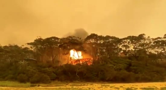 A view of an explosion after bushfires caused a house to go up in flames in Rosedale, New South Wales, Australia, December 31, 2019 in this picture obtained from social media. Mandatory credit BETHANY KELLY/via REUTERS
