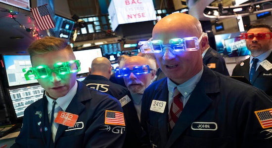 Stock traders wear New Year's 2020 party glasses at New York Stock Exchange, Tuesday, Dec. 31, 2019. Stocks slipped globally in quiet New Year's Eve trading Tuesday with many markets closed. Wall Street could close 2019 with back-to-back daily losses in a year that the U.S. posted the largest market gains since 2013. (AP Photo/Mark Lennihan) Stock traders wear New Year's 2020 party glasses at New York Stock Exchange, Tuesday, Dec. 31, 2019. Stocks slipped globally in quiet New Year's Eve trading Tuesday with many markets closed. Wall Street could close 2019 with back-to-back daily losses in a year that the U.S. posted the largest market gains since 2013. (AP Photo/Mark Lennihan)