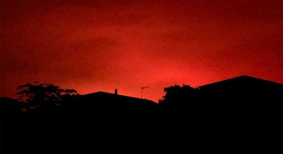 This Tuesday, Dec. 31, 2019, photo provided by Twitter user @AvaTheHuman shows red sky from wildfires burning, in Victoria, Australia. On Tuesday morning, 4,000 people in the coastal town of Mallacoota fled to the shore as winds pushed a fire toward their homes under a sky darkened by smoke and turned blood-red by flames. (@AvaTheHuman via AP)