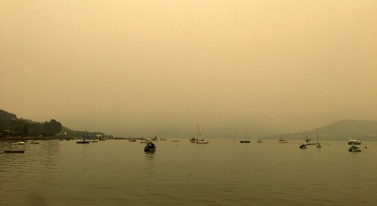 A yellow light illuminates the sky as the sun sets over Akaroa Harbor as smoke from the Australian wildfires arrives on the east coast of the South Island, New Zealand, Wednesday, Jan. 1, 2020. Australia deployed military ships and aircraft to help communities ravaged by apocalyptic wildfires that destroyed homes and sent thousands of residents and holidaymakers fleeing to the shoreline. (Eric Young via AP) A yellow light illuminates the sky as the sun sets over Akaroa Harbor as smoke from the Australian wildfires arrives on the east coast of the South Island, New Zealand, Wednesday, Jan. 1, 2020. Australia deployed military ships and aircraft to help communities ravaged by apocalyptic wildfires that destroyed homes and sent thousands of residents and holidaymakers fleeing to the shoreline. (Eric Young via AP)