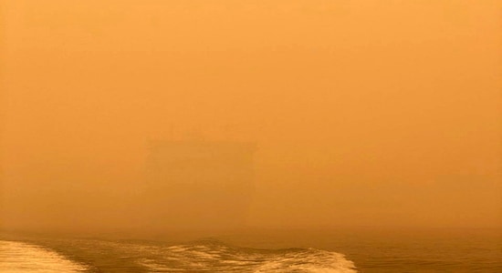 In this photo provided by the Australian Defence Force, HMAS Choules appears as a ghostly figure through smoke haze off the coast of Mallacoota, Australia, Thursday, Jan. 2, 2020. The Australian Defence Force is moving naval assets to Mallacoota on a supply mission that would last two weeks and helicopters would also fly in more firefighters since roads were inaccessible due to wildfires. (Australian Defence Force via AP) In this photo provided by the Australian Defence Force, HMAS Choules appears as a ghostly figure through smoke haze off the coast of Mallacoota, Australia, Thursday, Jan. 2, 2020. The Australian Defence Force is moving naval assets to Mallacoota on a supply mission that would last two weeks and helicopters would also fly in more firefighters since roads were inaccessible due to wildfires. (Australian Defence Force via AP)