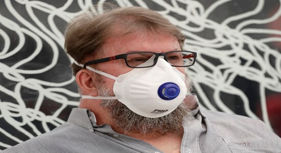 A commuter wears a mask as smoke shrouds the Australian capital of Canberra, Australia, Thursday, Jan. 2, 2020. Australia deployed military ships and aircraft to help communities ravaged by apocalyptic wildfires that destroyed homes and sent thousands of residents and holidaymakers fleeing to the shoreline. (AP Photo/Mark Baker) A commuter wears a mask as smoke shrouds the Australian capital of Canberra, Australia, Thursday, Jan. 2, 2020. Australia deployed military ships and aircraft to help communities ravaged by apocalyptic wildfires that destroyed homes and sent thousands of residents and holidaymakers fleeing to the shoreline. (AP Photo/Mark Baker)