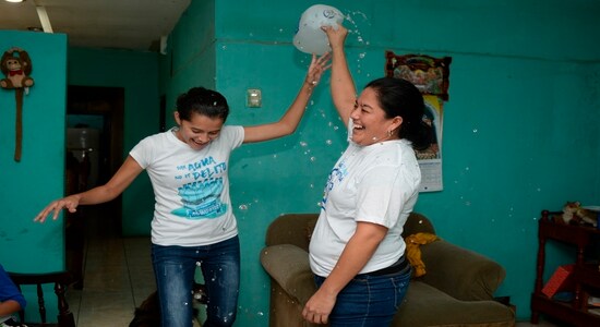 Ivania Alvarez shakes a jug of water as she celebrates with Neyma Hernandez after their release from prison, at her home in Managua, Nicaragua, Monday, Dec. 30, 2019. The women were part of a group known as “Banda de Aguadores,&quot; or water carriers, who were detained as political prisoners for taking water to hunger strikers. (AP Photo/Oscar Navarrete)