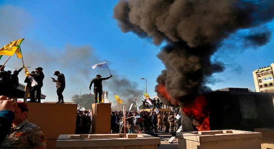 Protesters set fires in front of the U.S. embassy compound, in Baghdad, Iraq, Tuesday, Dec. 31, 2019. Dozens of angry Iraqi Shiite militia supporters broke into the U.S. Embassy compound in Baghdad on Tuesday. The breach at the embassy followed U.S. airstrikes on Sunday that killed 25 fighters of the Iran-backed militia in Iraq, the Kataeb Hezbollah. (AP Photo/Khalid Mohammed)
