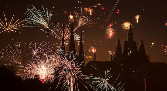 Fireworks light the sky above the St. Severi's Church, left, and the Mariendom (Cathedral of Mary), right, during New Year's celebrations in Erfurt, central Germany, Wednesday, Jan. 1, 2020. (AP Photo/Jens Meyer)