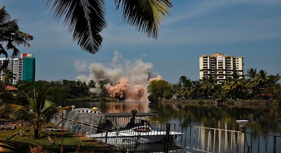 Alpha Serene, a water-front residential apartment, is razed to the ground by controlled implosion in Kochi, India, Saturday, Jan. 11. 2020. Authorities in southern Kerala state on Saturday razed down two high-rise luxury apartments using controlled implosion in one of the largest demolition drives in India involving residential complexes for violating environmental norms. (AP Photo/R S Iyer)
