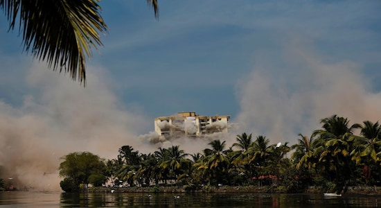 Alpha Serene, a water-front residential apartment, is razed to the ground by controlled implosion in Kochi, India, Saturday, Jan. 11. 2020. Authorities in southern Kerala state on Saturday razed down two high-rise luxury apartments using controlled implosion in one of the largest demolition drives in India involving residential complexes for violating environmental norms. (AP Photo/R S Iyer)