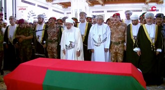 This image made from video shows Oman's new sultan Haitham bin Tariq Al Said, center between two men with daggers, attends the prayer ceremony over Sultan Qaboos coffin at Sultan Qaboos Grand Mosque in Muscat, Oman, Saturday, Jan. 11, 2020. Sultan Qaboos bin Said, the Mideast's longest-ruling monarch who seized power in a 1970 palace coup and pulled his Arabian sultanate into modernity while carefully balancing diplomatic ties between adversaries Iran and the U.S., has died. He was 79. (Oman TV via AP)