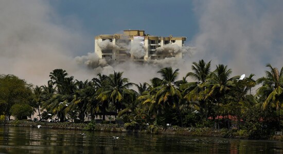 The second tower of water-front residential apartment Alpha Serene is demolished using controlled implosion in Kochi, India, Saturday, Jan. 11. 2020. Authorities in southern Kerala state on Saturday razed down two high-rise luxury apartments using controlled implosion in one of the largest demolition drives in India involving residential complexes for violating environmental norms. (AP Photo/R S Iyer)