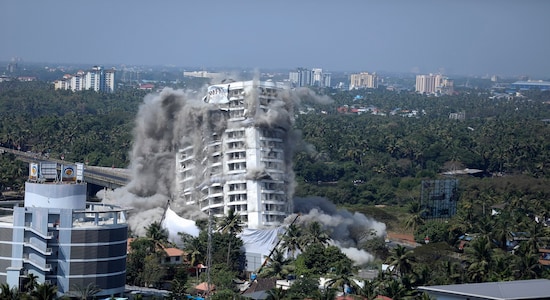 High-rise luxury apartment apartment Holy Faith H2O is brought to the ground by controlled implosion in Kochi, India, Saturday, Jan. 11. 2020. Authorities in southern Kerala state on Saturday razed down two high-rise luxury apartments using controlled implosion in one of the largest demolition drives in India involving residential complexes for violating environmental norms. (AP Photo/Prakash Elamakkara)