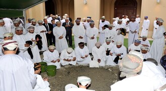 In this photo made available by Oman News Agency, Omani officials pray over the grave of Sultan Qaboos after his burial in Muscat, Oman, Saturday, Jan. 11, 2020. Sultan Qaboos bin Said, the Mideast's longest-ruling monarch who seized power in a 1970 palace coup and pulled his Arabian sultanate into modernity while carefully balancing diplomatic ties between adversaries Iran and the U.S., has died. He was 79. (Oman News Agency via AP)