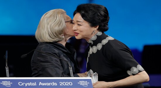 Dancer and coreographer Jin Xing, from China, receives a Crystal Award from Hilde Schwab, Chairwoman and Co-Founder of the World Economic Forum's World Arts Forum, during the ceremony for the Crystal Awards at the annual meeting of the World Economic Forumin Davos, Switzerland, Monday, Jan. 20, 2020. The 50th annual meeting of the forum will take place in Davos from Jan. 21 until Jan. 24, 2020. (AP Photo/Markus Schreiber)