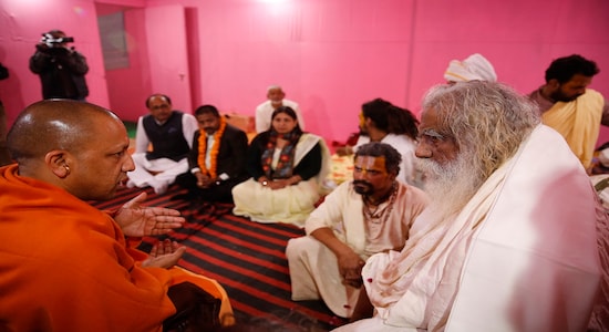 Uttar Pradesh state Chief Minister Yogi Adityanath, left, meets Hindu religious leaders at the Sangam, the confluence of rivers Ganges and Yamuna, on the eve of the Basant Panchami festival in Prayagraj, India, Wednesday, Jan. 29, 2020. (AP Photo/Rajesh Kumar Singh)