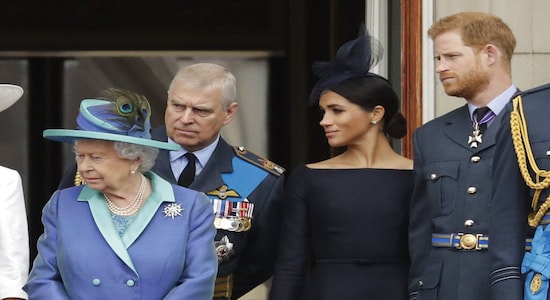 FILE - In this Tuesday, July 10, 2018 file photo Britain's Queen Elizabeth II, Prince Andrew, Meghan the Duchess of Sussex and Prince Harry stand on a balcony to watch a flypast of Royal Air Force aircraft pass over Buckingham Palace in London. As part of a surprise announcement distancing themselves from the British royal family, Prince Harry and his wife Meghan declared they will &quot;work to become financially independent&quot; _ a move that has not been clearly spelled out and could be fraught with obstacles. (AP Photo/Matt Dunham, File)