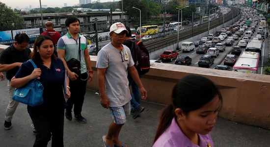 No 2 | Manila | The capital of the Philippines ranks second on the list with congestion levels at 71 percent. Pictured: Commuters walk on an overpass walkway overlooking heavy traffic jam during rush hours along the main highway in Manila. (Image: Reuters)