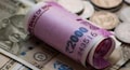 Rupee recovers from lows to end nearly flat against US dollar