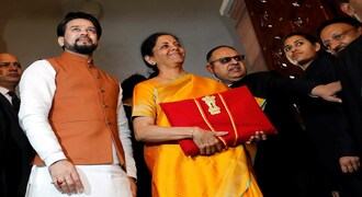 Finance Minister Nirmala Sitharaman is flanked by junior Finance Minister Anurag Thakur as she arrives to present the budget in Parliament in New Delhi, India, February 1, 2020. REUTERS/Altaf Hussain