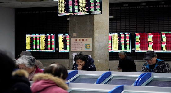 Investors look at computer screens showing stock information at a brokerage house in Shanghai Investors look at computer screens showing stock information at a brokerage house in Shanghai