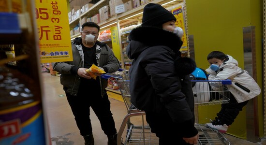 Customers wearing face masks shop inside a supermarket, as the country is hit by an outbreak of the novel coronavirus, in Beijing, China February 15, 2020. REUTERS/Stringer