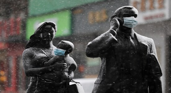 Statues with face masks on are seen amid snow in Wuhan, the epicentre of the novel coronavirus outbreak, in Hubei province, China February 15, 2020. China Daily via REUTERS