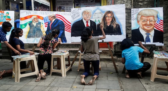 Students paint murals of U.S. President Donald Trump and first lady Melania Trump on canvas sheets along a street in Mumbai. (REUTERS/Francis Mascarenhas)