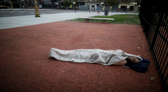 A homeless man sleeps in the plaza across the street from Congress in Buenos Aires, Argentina, Wednesday, Feb. 5, 2020. Senators will debate a government proposed bill on Wednesday to renegotiate the restructuring of the nation's $100 billion debt, which officials say is not payable amid a deep recession. (AP Photo/Natacha Pisarenko)