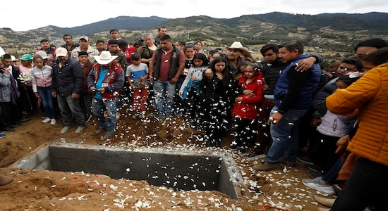 Flower petals fall as family and friends grieve around the grave of community activist Homero Gomez Gonzalez in Ocampo, Michoacan state, Mexico, Friday, Jan. 31, 2020. Hundreds of farmers and agricultural workers thronged the funeral on Friday, and the homage to the anti-logging activist was like a tribute to the monarch butterfly he so staunchly defended. (AP Photo/Rebecca Blackwell) Flower petals fall as family and friends grieve around the grave of community activist Homero Gomez Gonzalez in Ocampo, Michoacan state, Mexico, Friday, Jan. 31, 2020. Hundreds of farmers and agricultural workers thronged the funeral on Friday, and the homage to the anti-logging activist was like a tribute to the monarch butterfly he so staunchly defended. (AP Photo/Rebecca Blackwell)