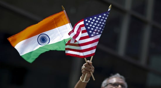 FILE PHOTO: A man holds the flags of India and the U.S. while people take part in the 35th India Day Parade in New York August 16, 2015. REUTERS/Eduardo Munoz/File Photo
