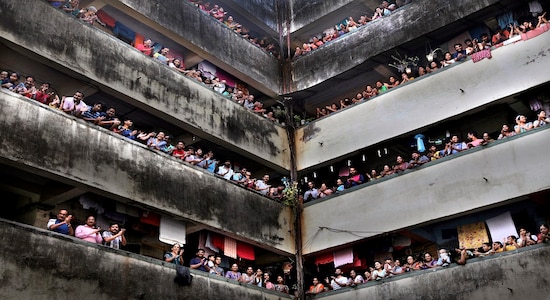 People clap from balconies in show of appreciation to health care workers at a Chawl in Mumbai, India, Sunday, March 22, 2020. India is Sunday observing a 14-hour &quot;people's curfew&quot; called by Prime Minister Narendra Modi in order to stem the rising coronavirus caseload in the country of 1.3 billion For most people, the new coronavirus causes only mild or moderate symptoms. For some it can cause more severe illness. (AP Photo/Rafiq Maqbool)