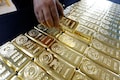 Gold set for third straight weekly gain as virus cases soar