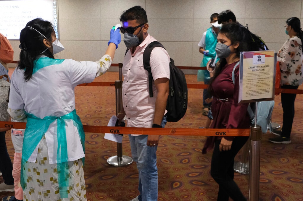 Passengers undergo temperature check as a precaution against a new coronavirus at Chhatrapati Shivaji International Airport in Mumbai, India, Tuesday, March 10, 2020. For most people, the new coronavirus causes only mild or moderate symptoms, such as fever and cough. For some, especially older adults and people with existing health problems, it can cause more severe illness, including pneumonia. (AP Photo/Rafiq Maqbool)